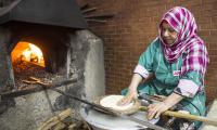 Morocco. A woman preparing bread at a local restaurant in Agadir.  © FAO/Alessandra Benedetti