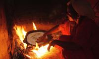 Morocco. Oujda. A farmer's wife cooking a typical bread in a wood burning oven. © FAO/Giampiero Diana