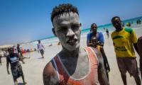A young man stands on Lido Beach in Mogadishu. UN Photo/Stuart Price